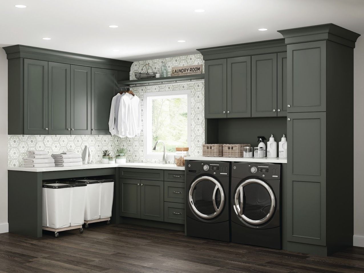 Dark green laundry room with cabinets, washer/dryer, and a hanging rod.