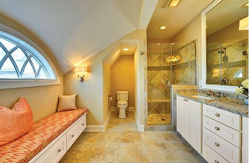 Two-story house with a brick and beige facade, dark roof, and two-car garage.