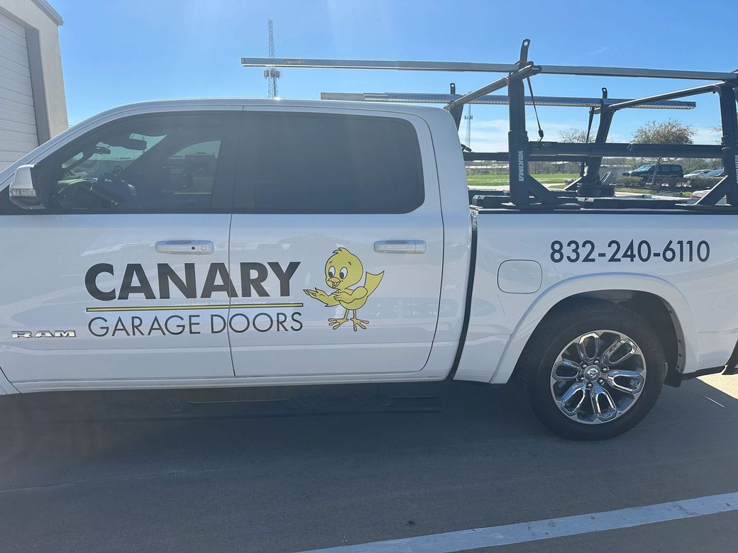 A white pickup truck with a ladder rack, featuring the company name