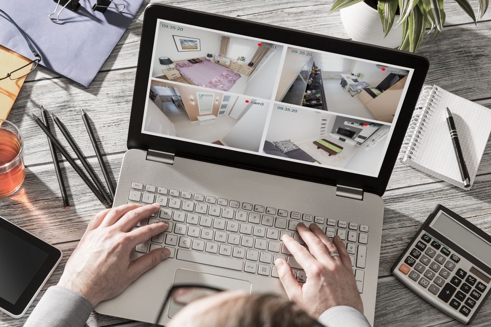 A person is typing on a laptop with a calculator on the desk — Locksmith in Tweed Heads, NSW