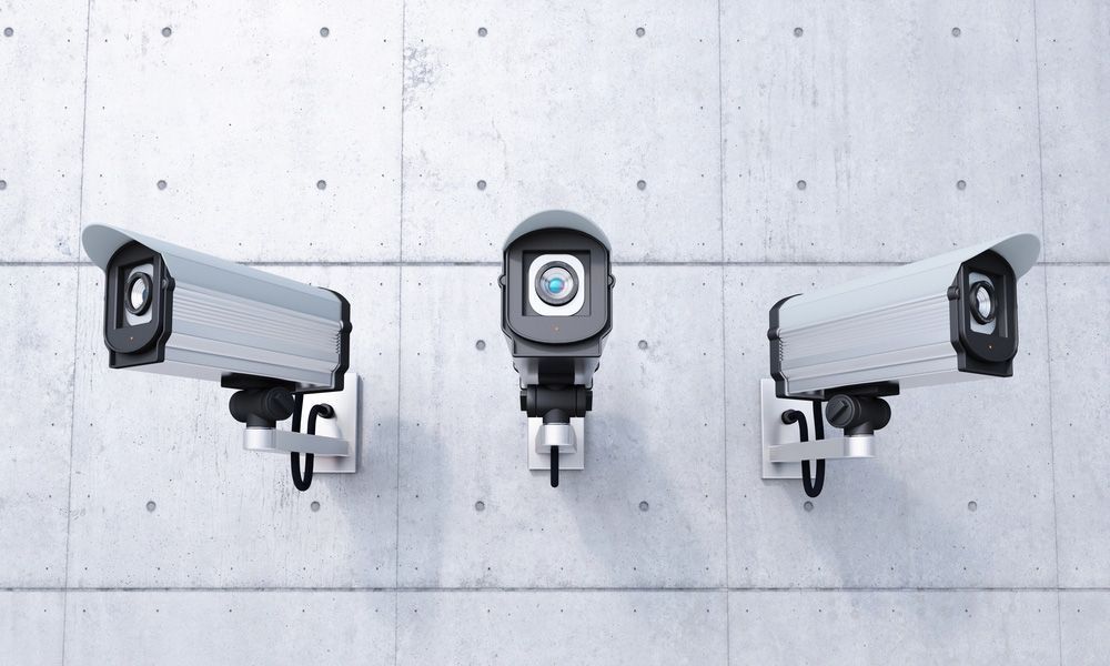 Three security cameras are mounted to a concrete wall — Locksmith in Tweed Heads, NSW