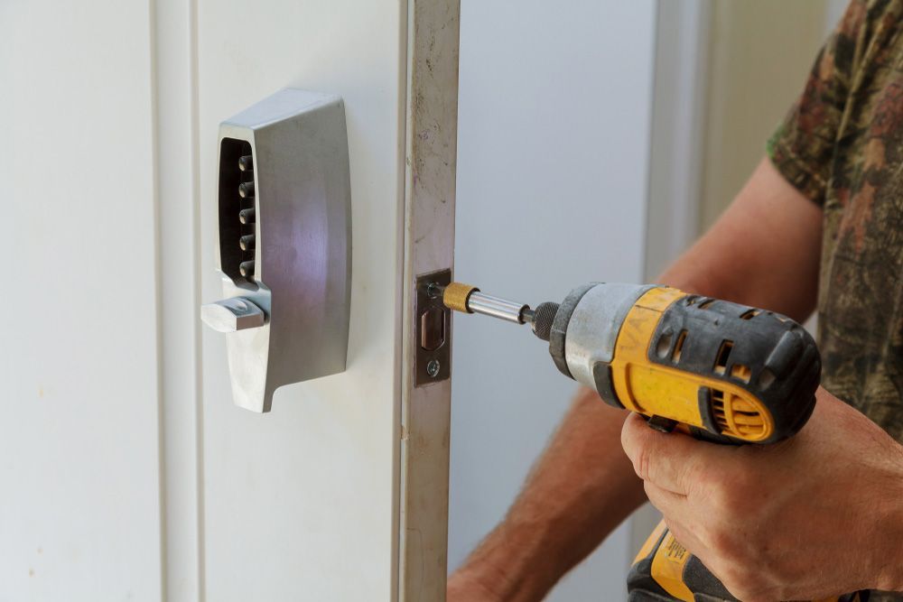 Man installing of the door lock security — Locksmith in Tweed Heads, NSW