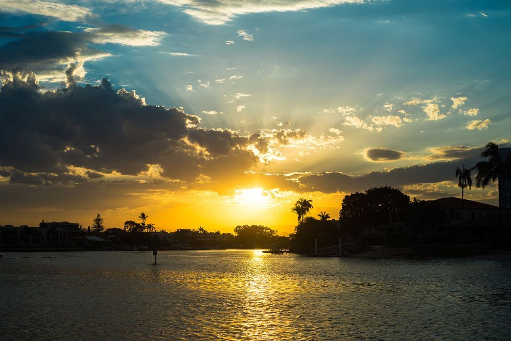 Sun is setting over a body of water — Locksmith in Nerang, QLD