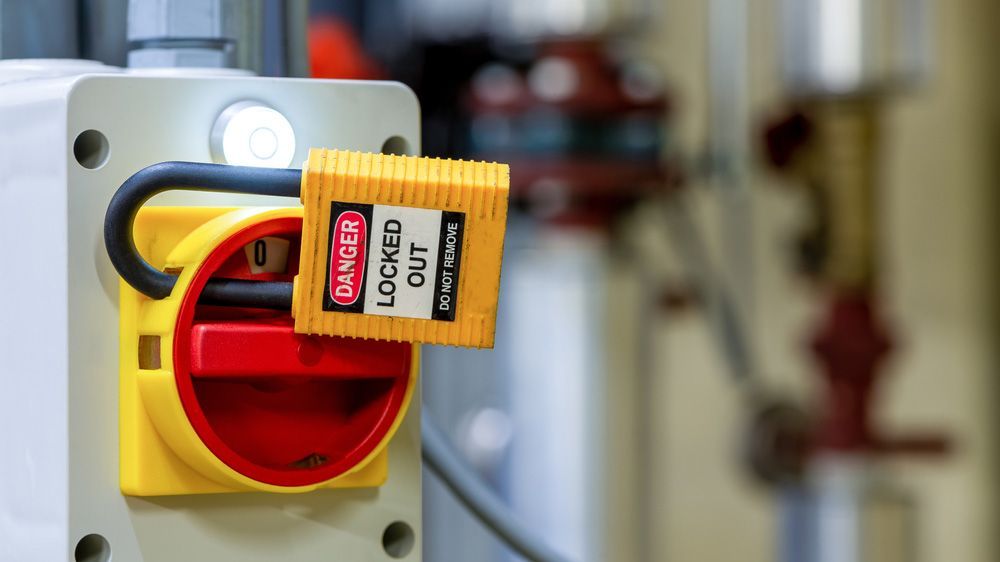 A yellow danger lock is attached to a red switch — Locksmith in Helensvale, QLD