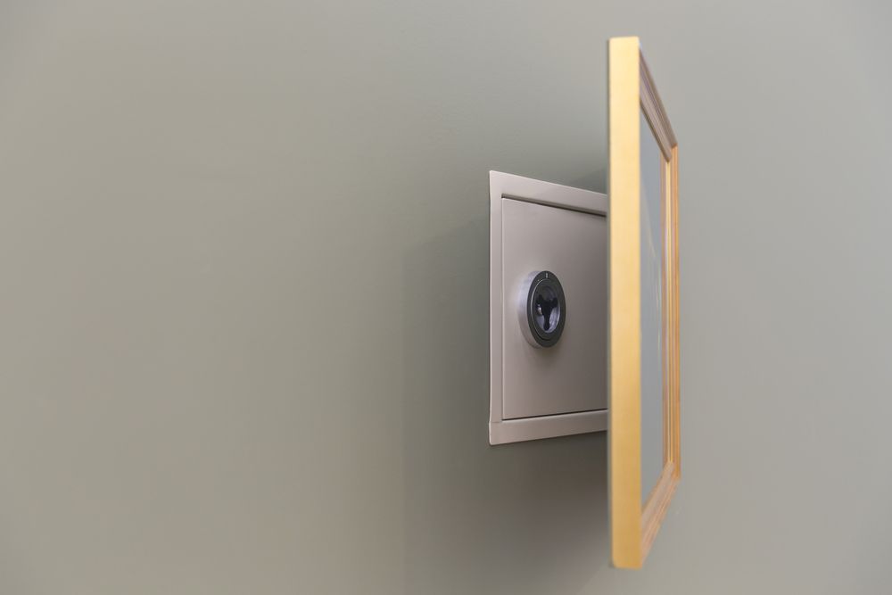 A Picture Frame With A Safe Behind It — Border Locksmiths & Electronics In Tweed Heads, NSW