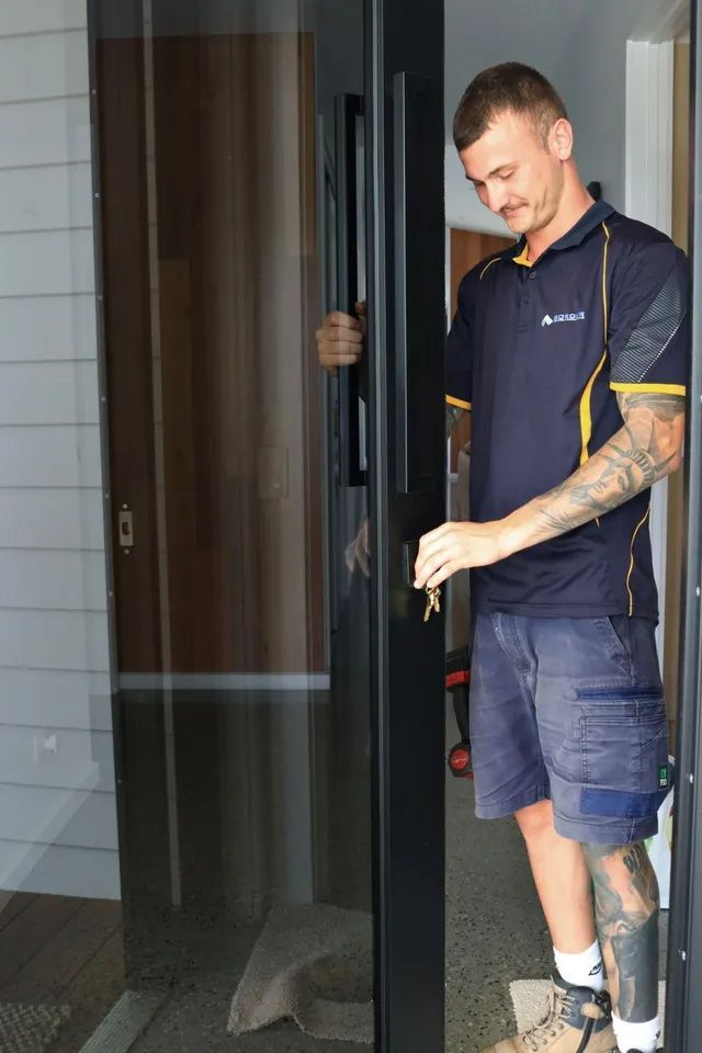 A man wearing a shirt that says ' australs ' on it — Locksmith in Tweed Heads, NSW