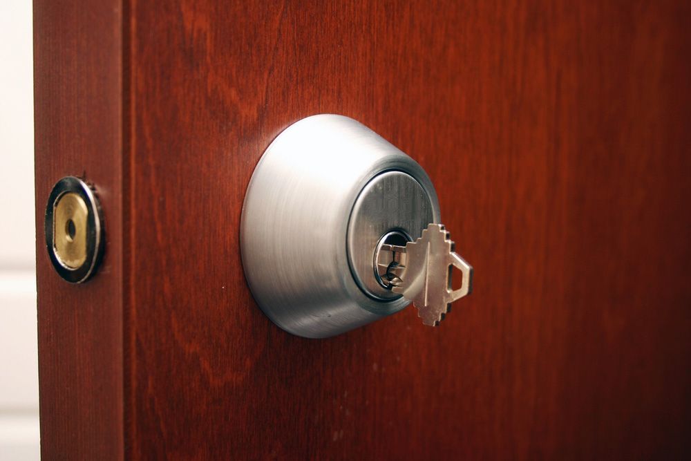 A key in a lock on a wooden door — Locksmith in Tweed Heads, NSW
