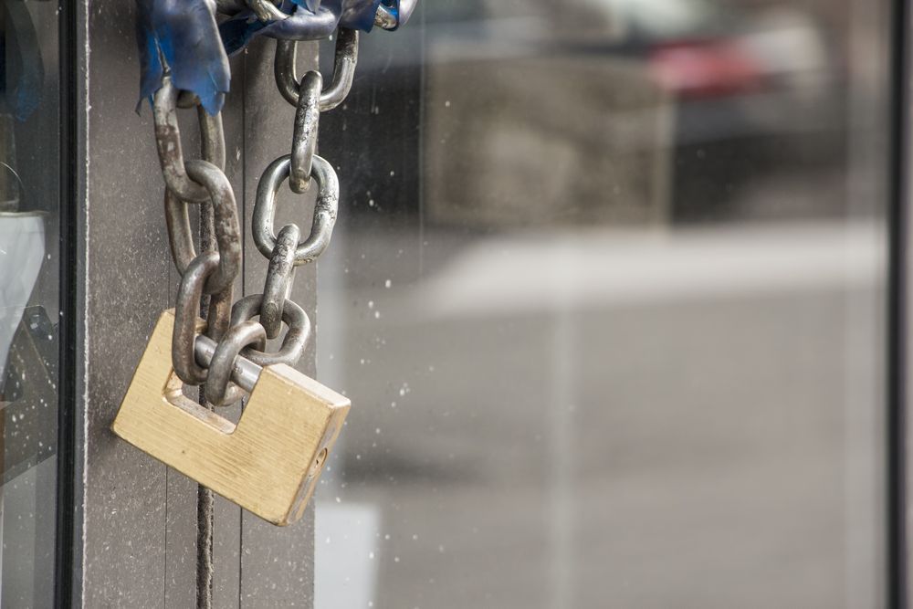 A padlock is attached to a chain on a door — Locksmith in Tweed Heads, NSW