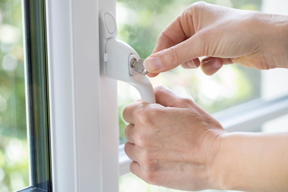 a person is opening a window with a key