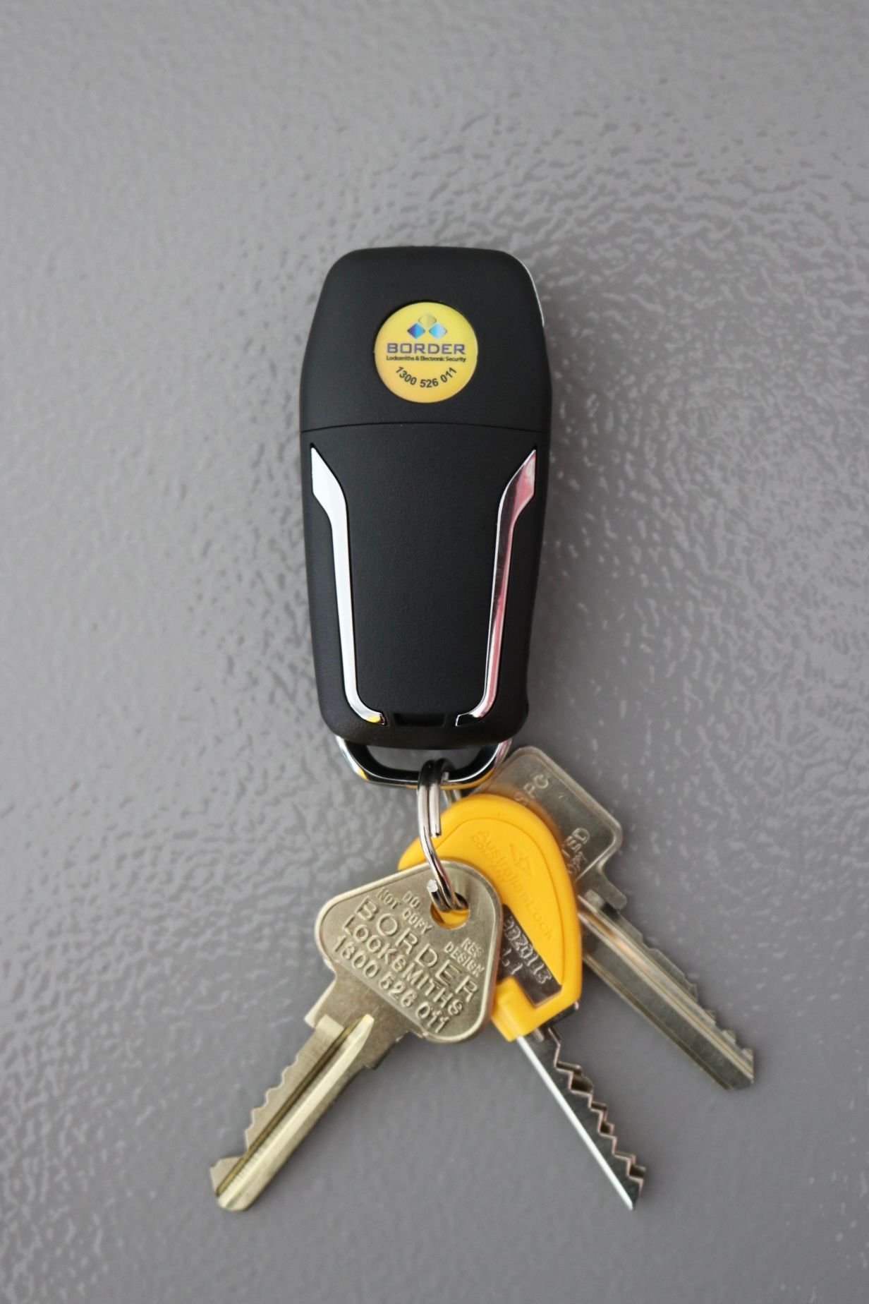 A man is looking through the window of a car — Locksmith in Tweed Heads, NSW