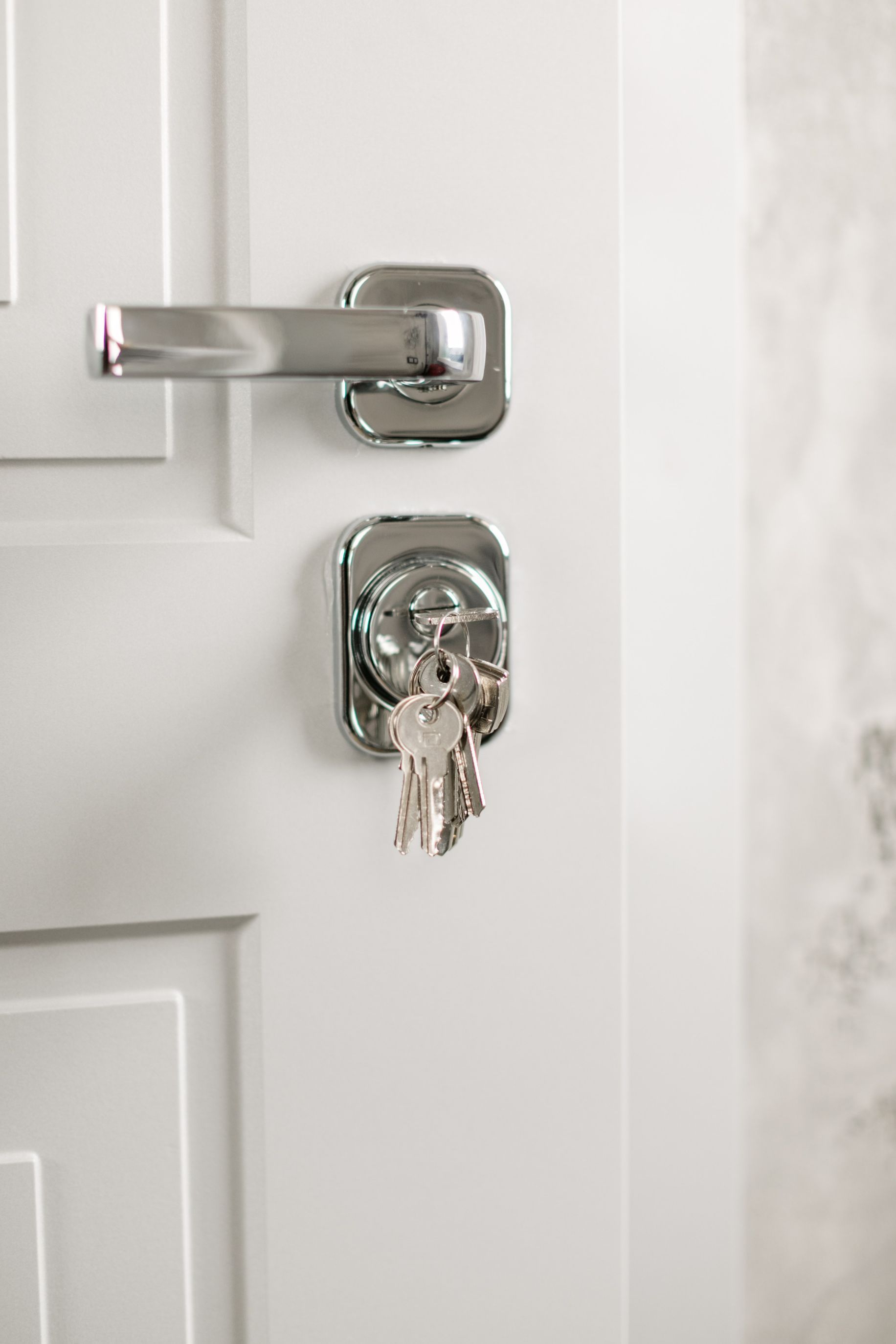 Bunch of keys are hanging from a door lock — Locksmith in Tweed Heads, NSW