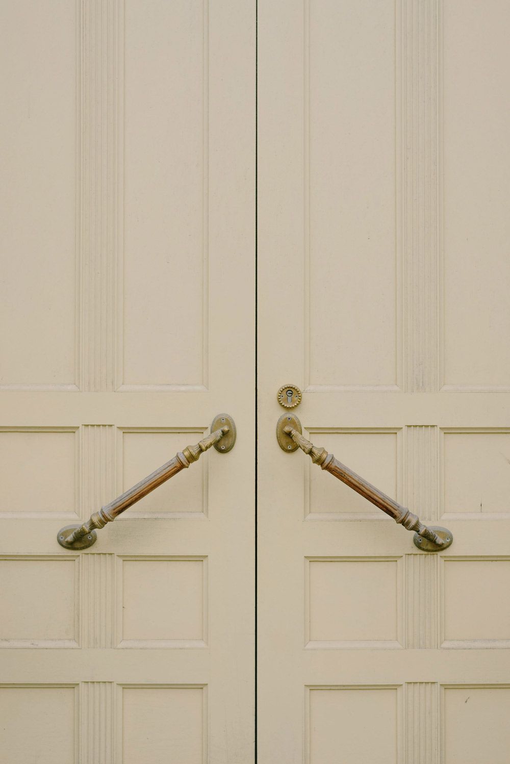 Pair of white doors with brass handles — Locksmith in Byron Bay, NSW