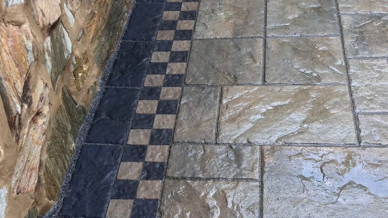A close up of a stone floor with a checkered pattern.