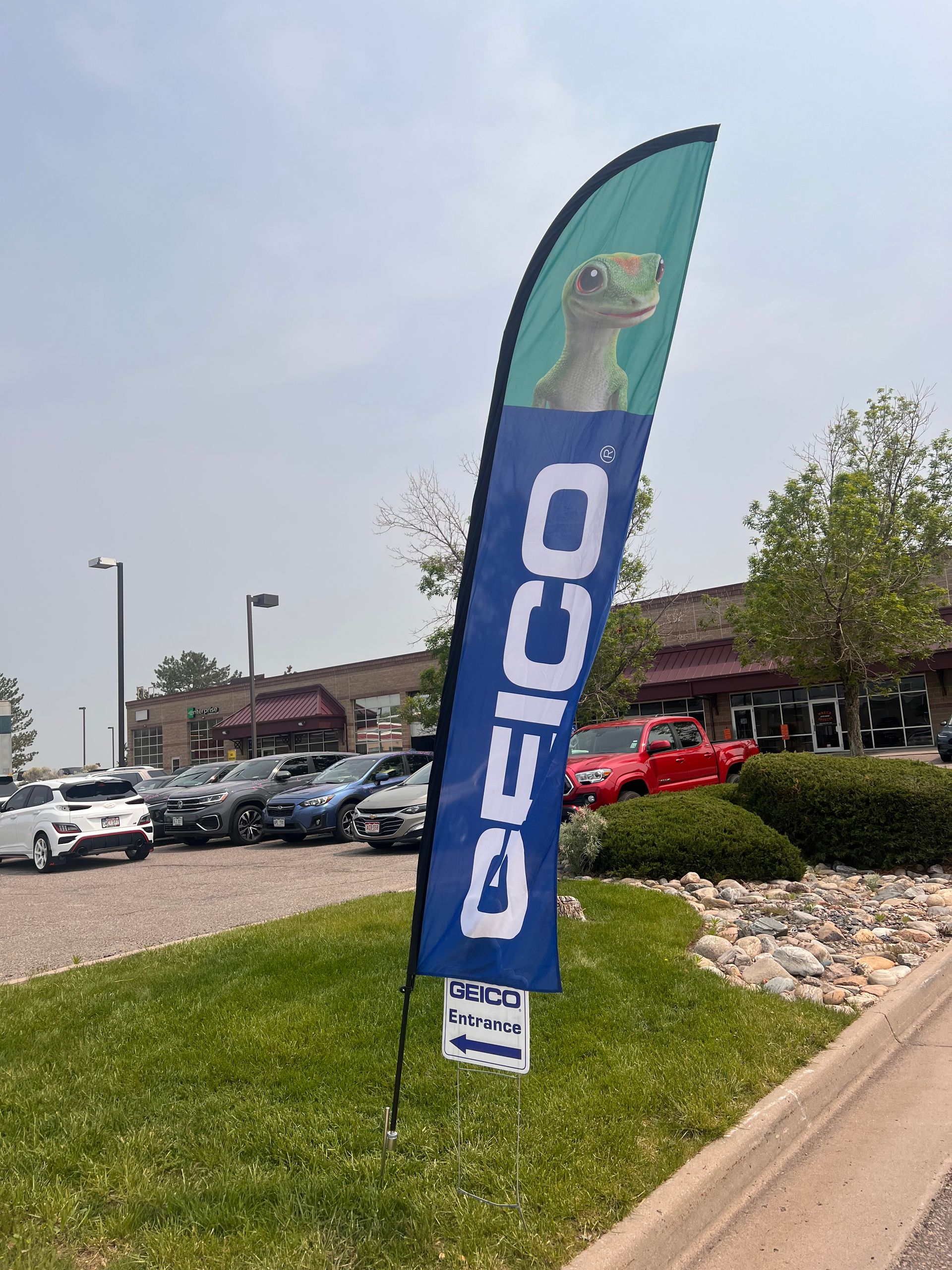 A blue and green deico flag is sitting on the side of the road.