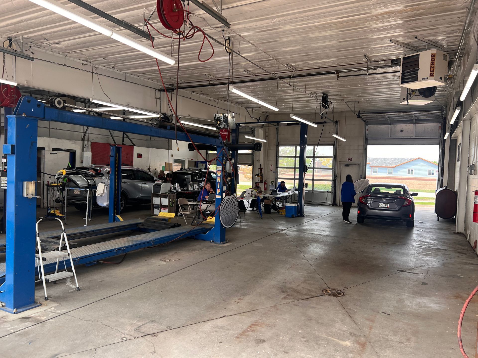 A car is being worked on in a garage.