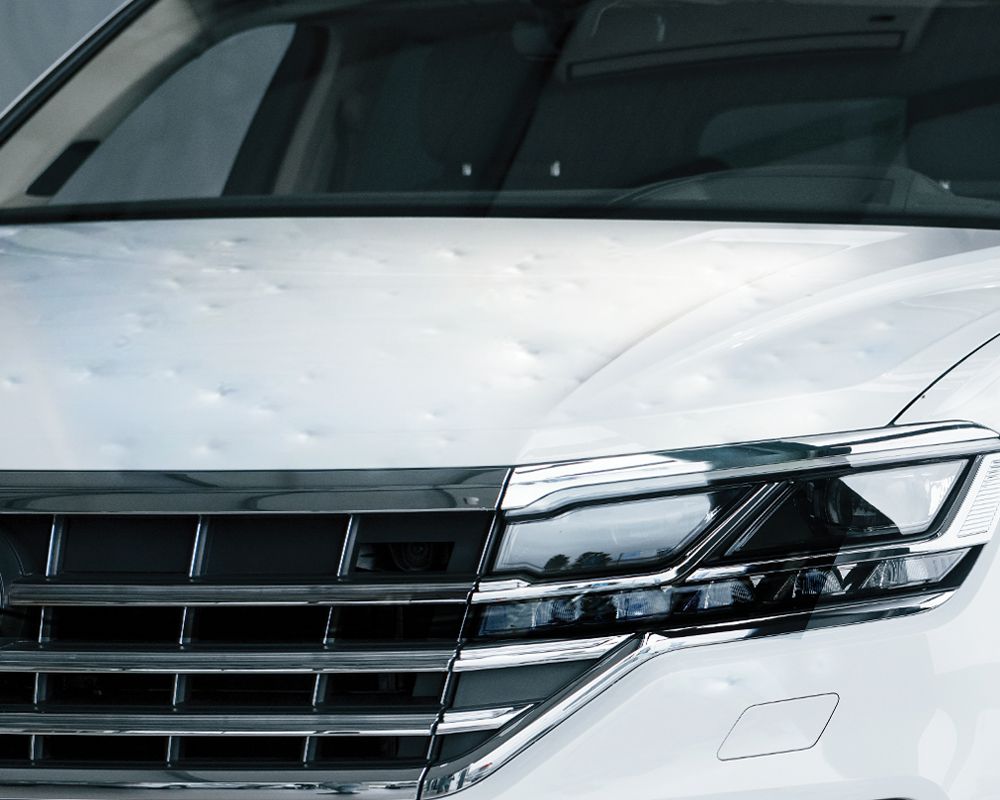 A close up of the front of a white car