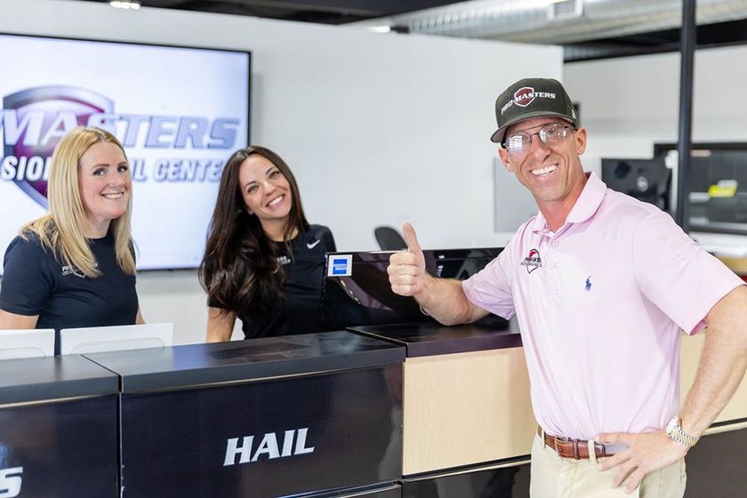 A man is cutting down a tree with a chainsaw
