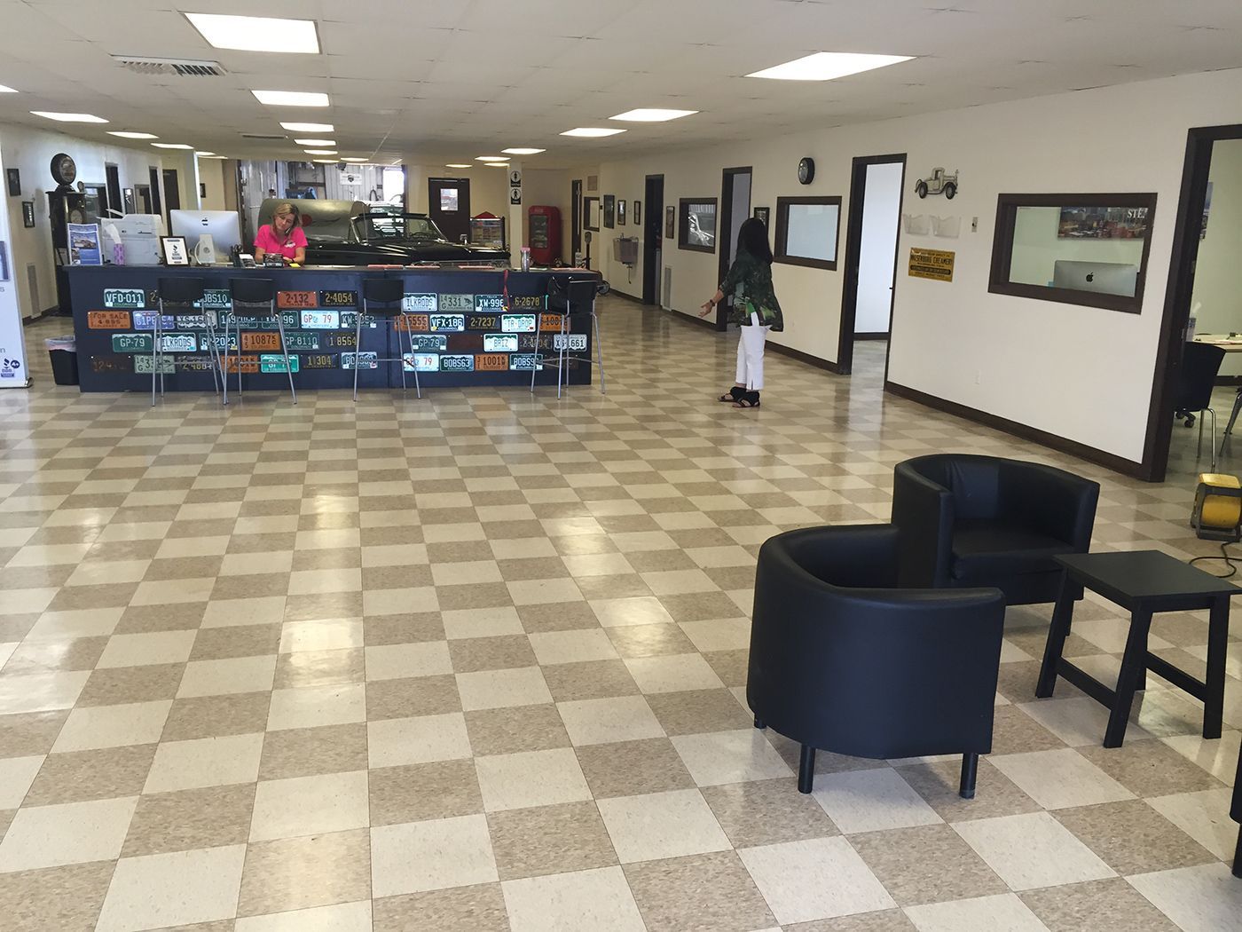 A large room with a checkered floor and chairs