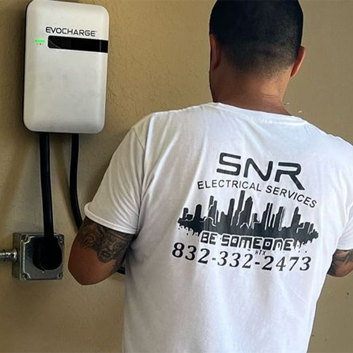 Man installing an electric vehicle charger, labeled 