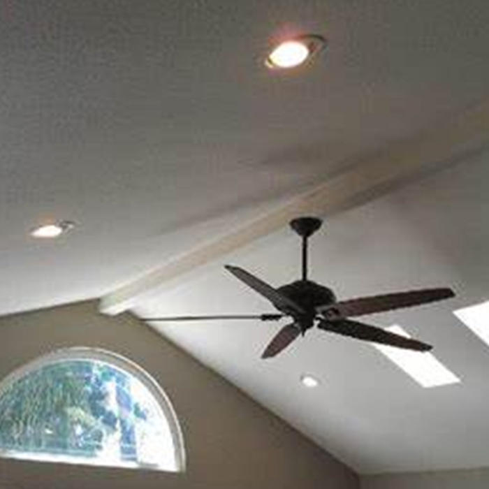 Ceiling with recessed lights, ceiling fan, and arched window.