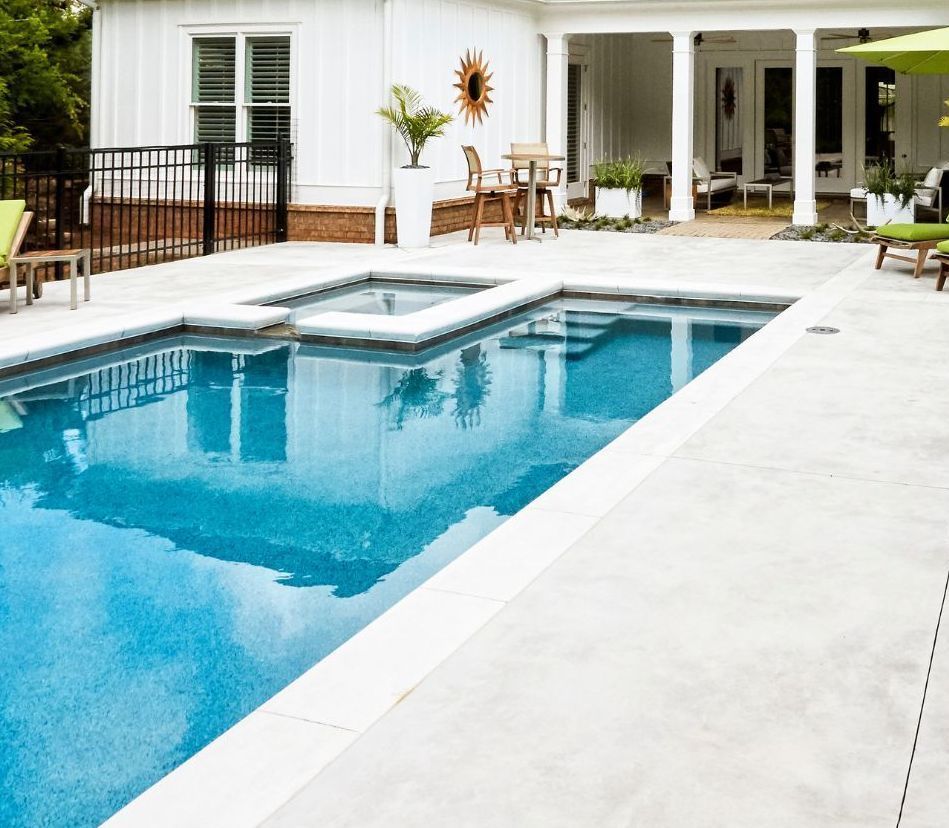 Concrete pool surrounds in backyard