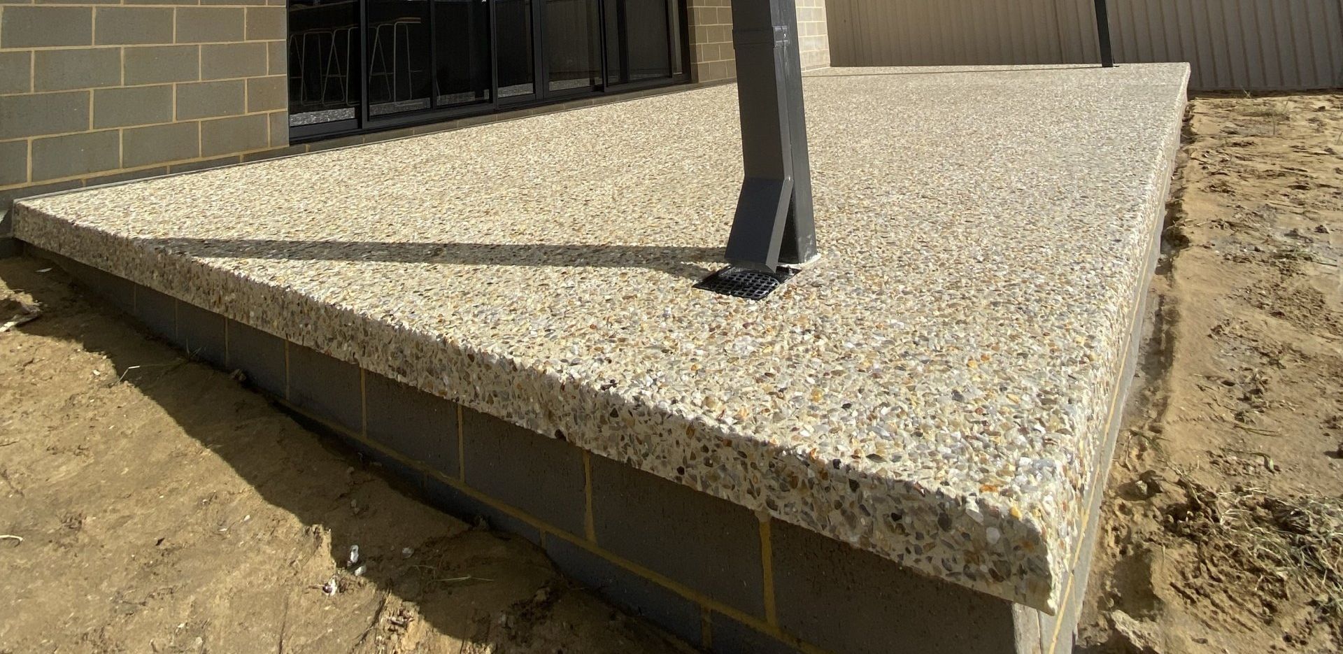 Exposed Aggregate patio flooring with over hang design