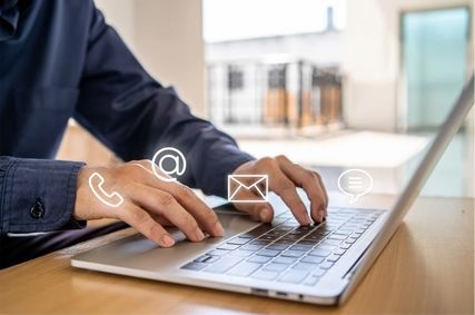 Person typing on a laptop.