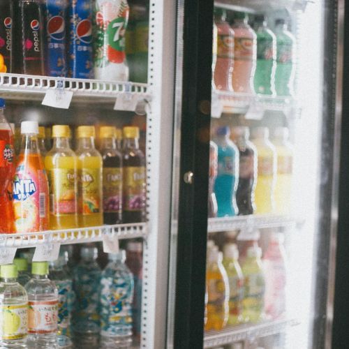 A refrigerator filled with sodas including fanta and pepsi