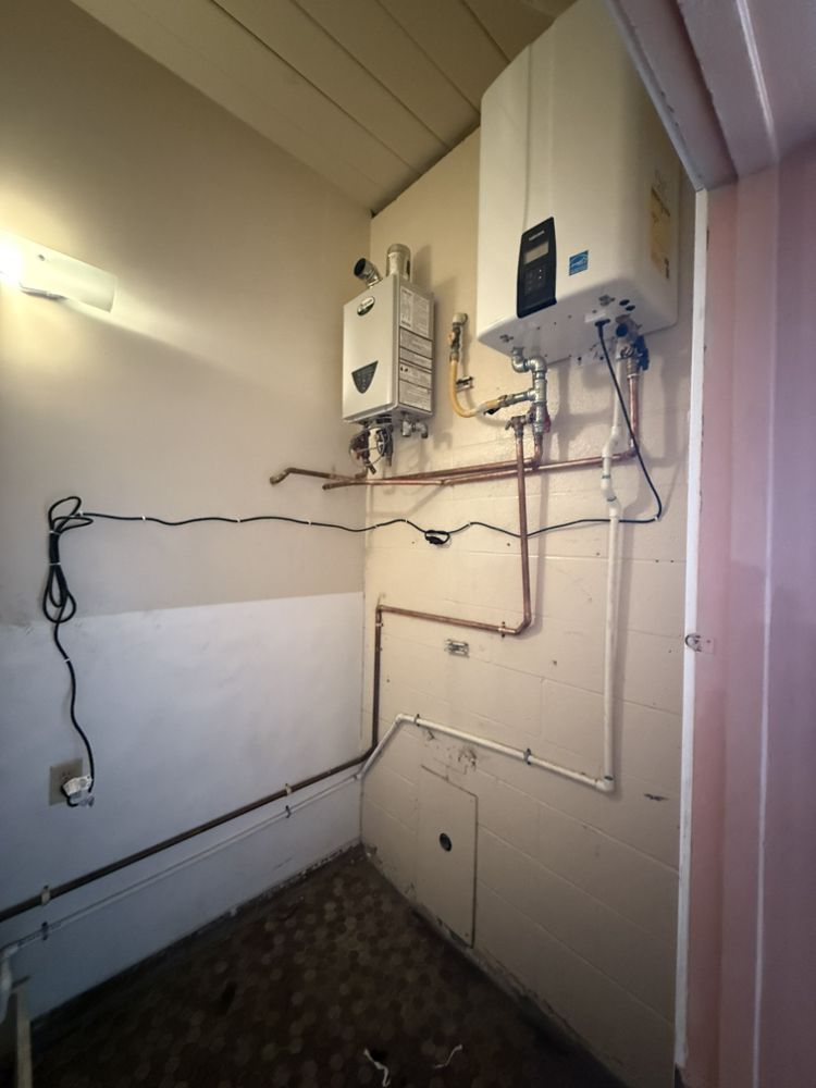 A room with two water heaters on the wall