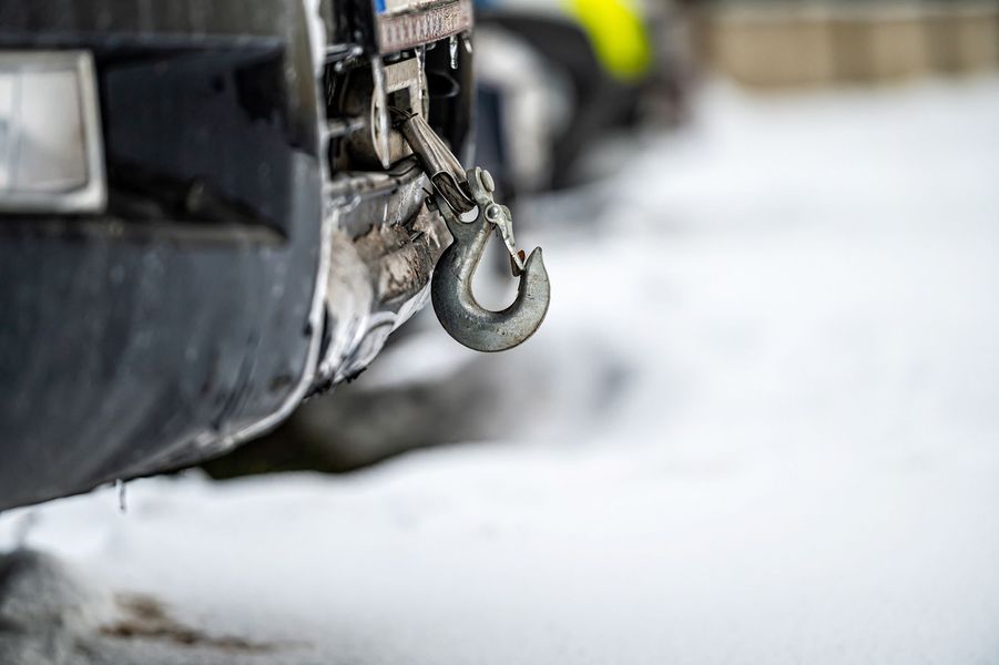 A close up of a car with a winch attached to it.