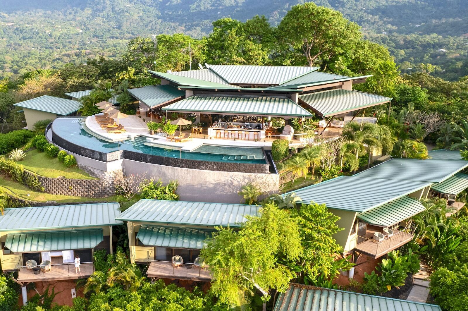 An aerial view of a large house surrounded by trees