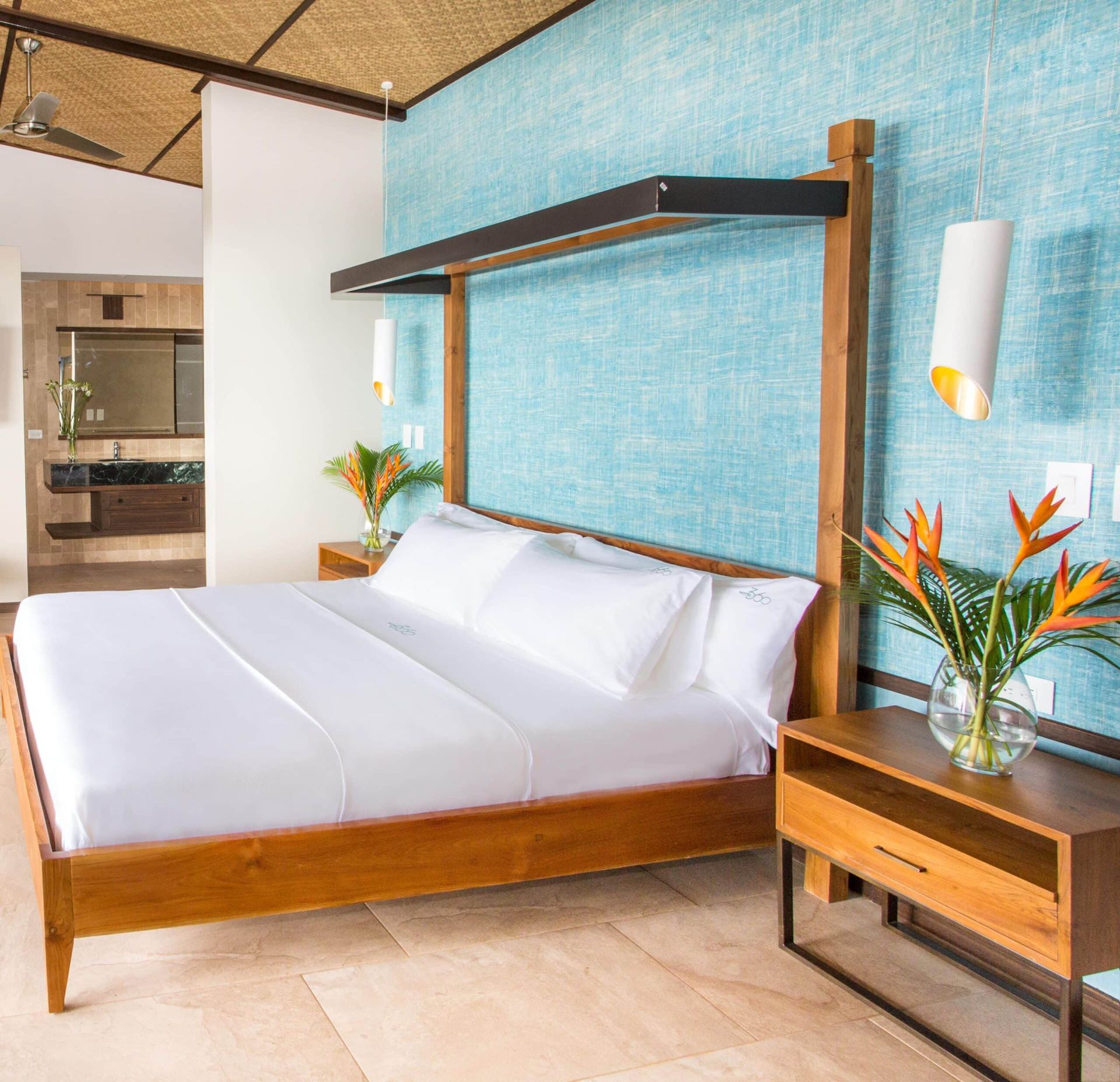 A bedroom with a king size bed and a blue wall