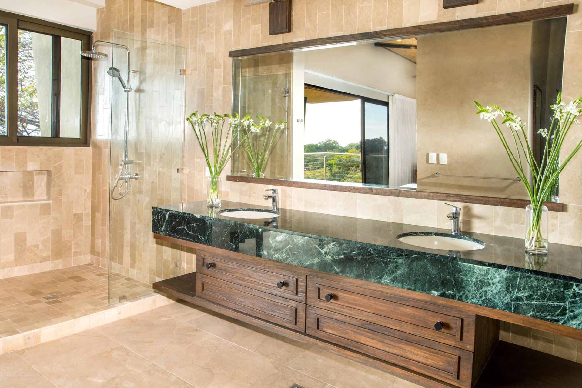 A bathroom with two sinks and a large mirror