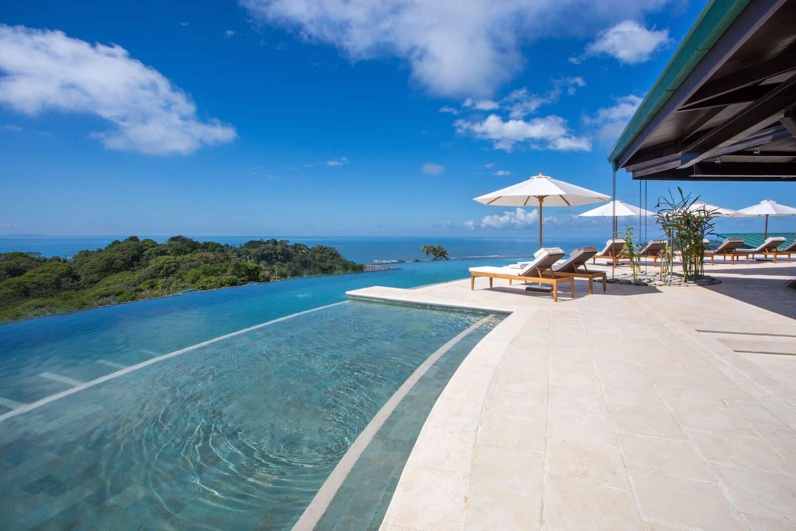 A large swimming pool with a view of the ocean