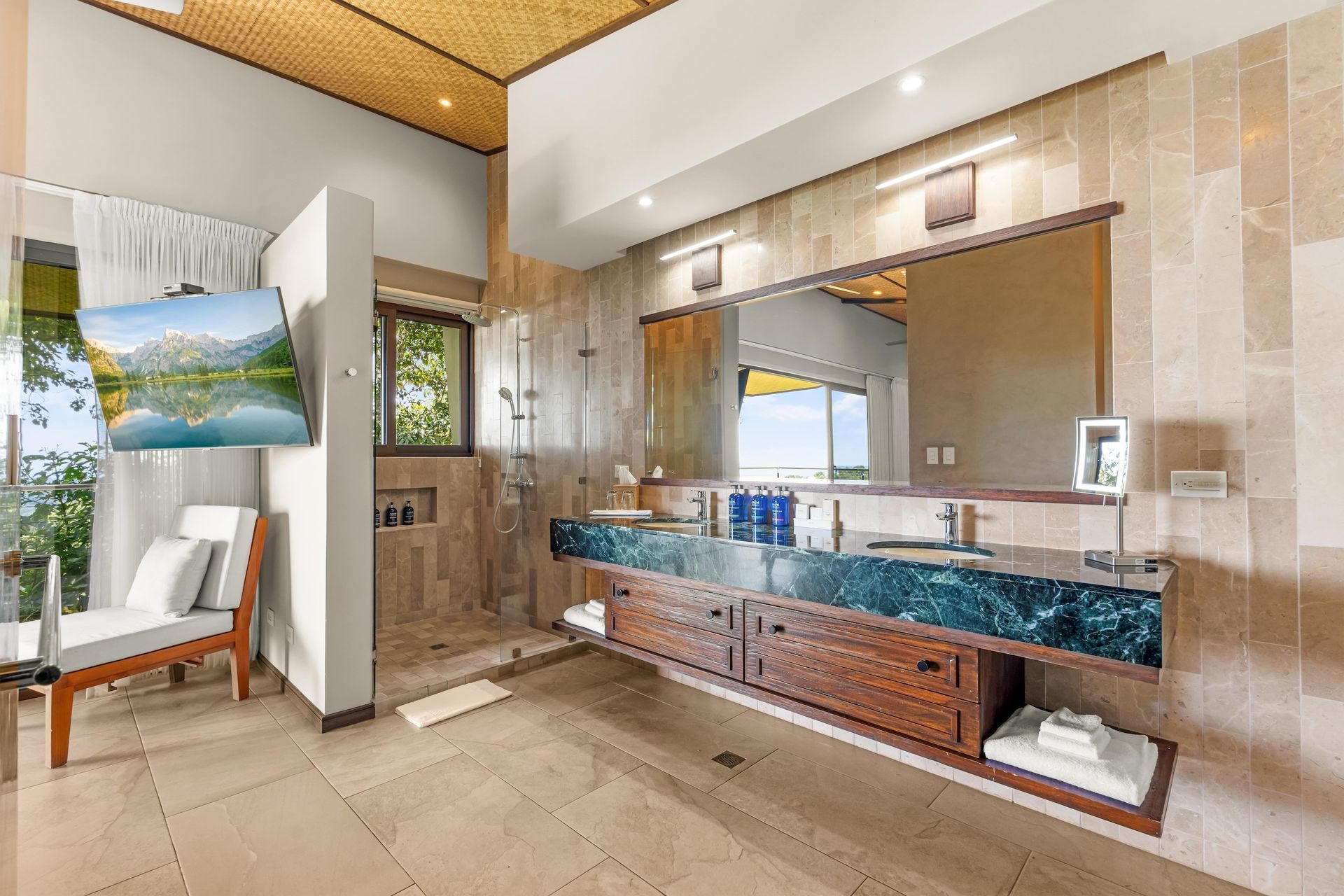 A bathroom with two sinks and a large mirror.