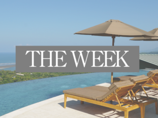 A swimming pool with a sign that says the week