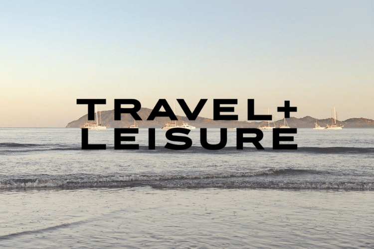 A logo for travel + leisure with a beach in the background