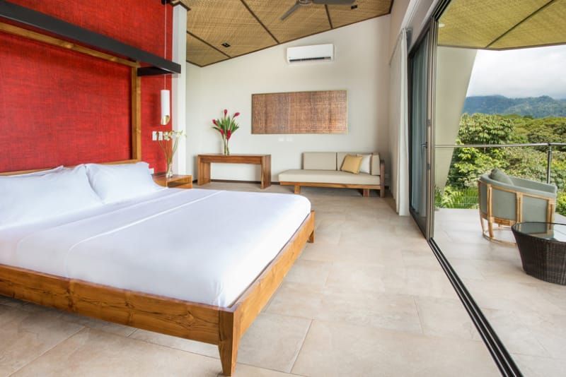 A bedroom with a large bed and a couch