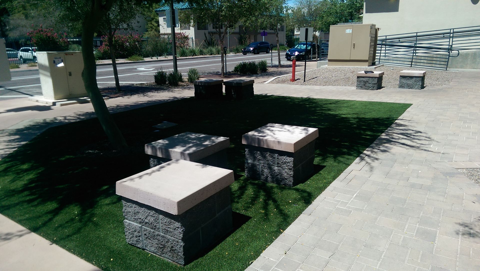 A group of concrete blocks are sitting on top of a lush green lawn