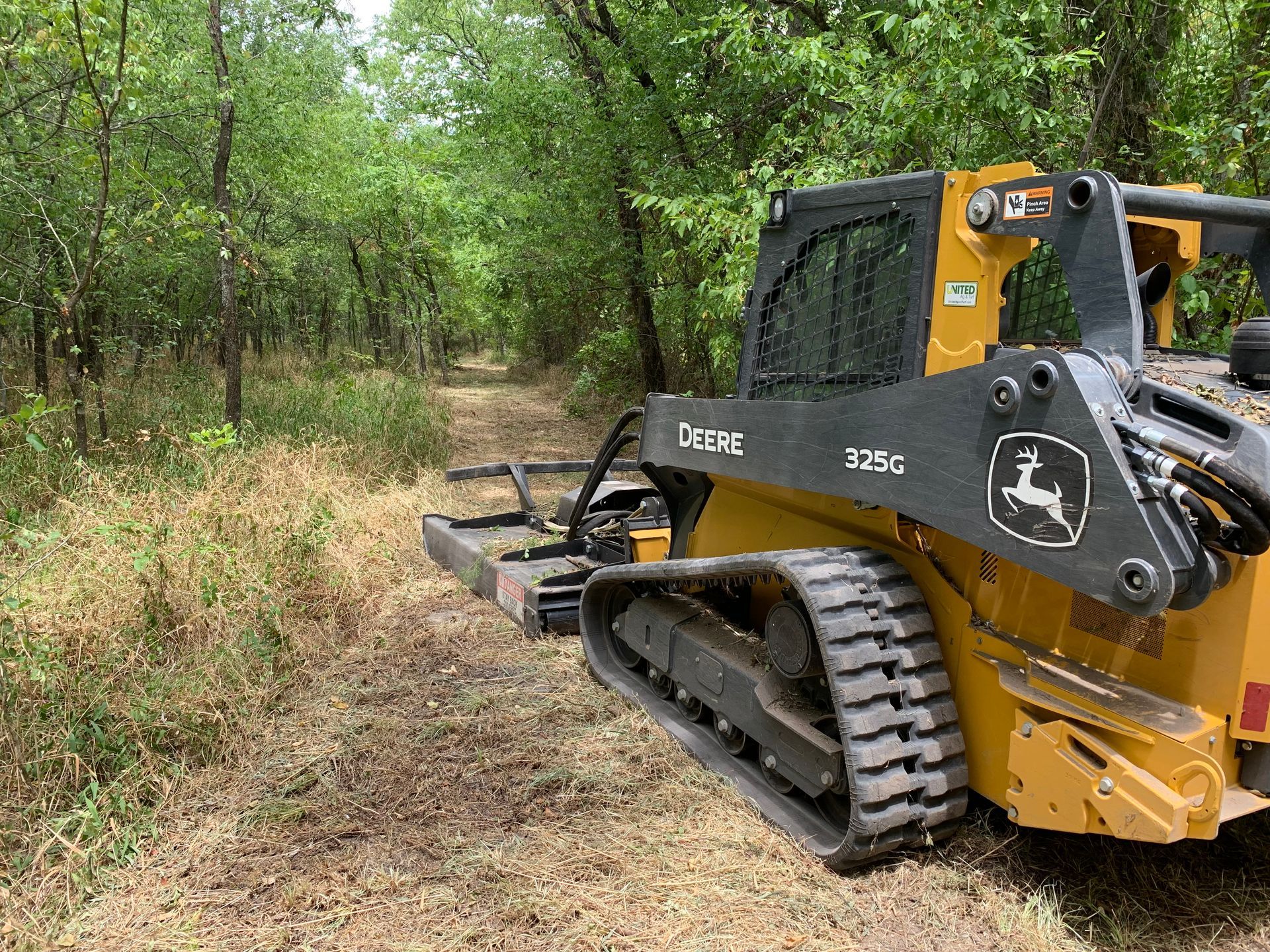 Skid steer land clearing, trail clearing.