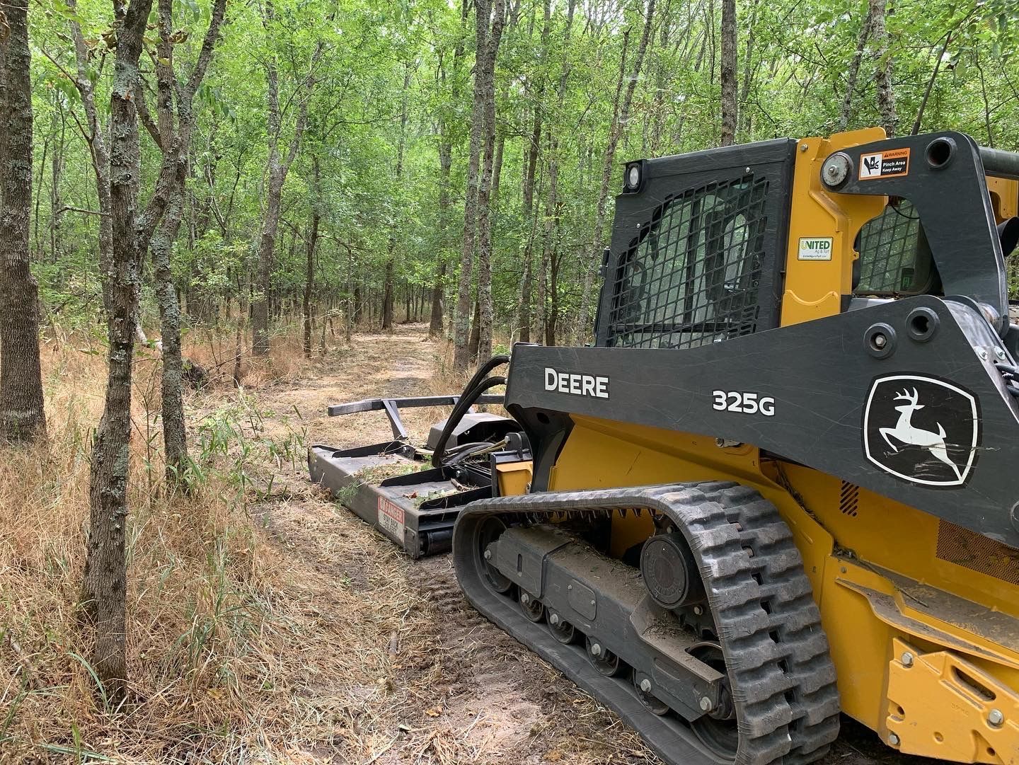 Brush clearing skid steer, making trails.