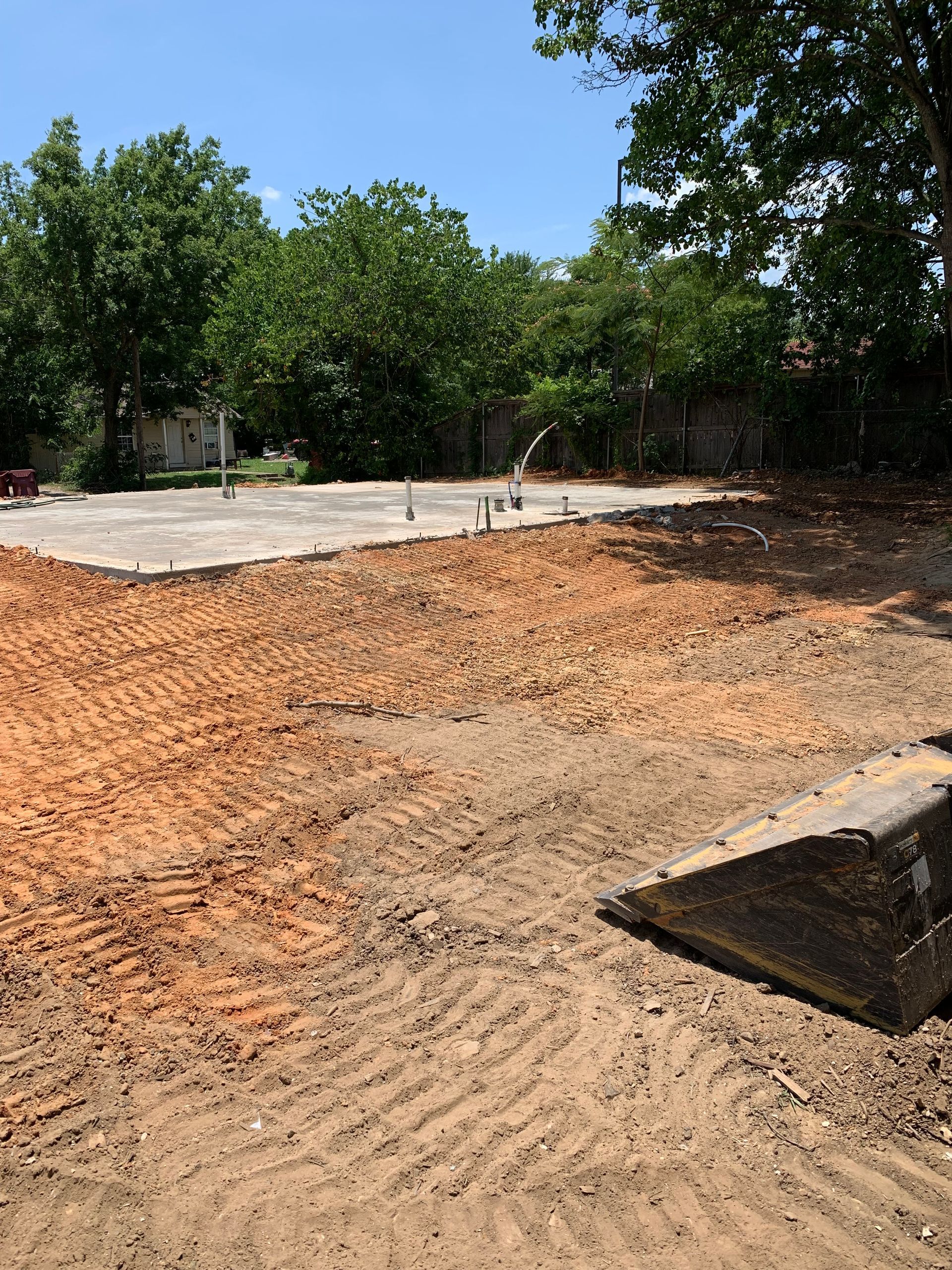 Construction site with dirt, concrete slab, ground clearing