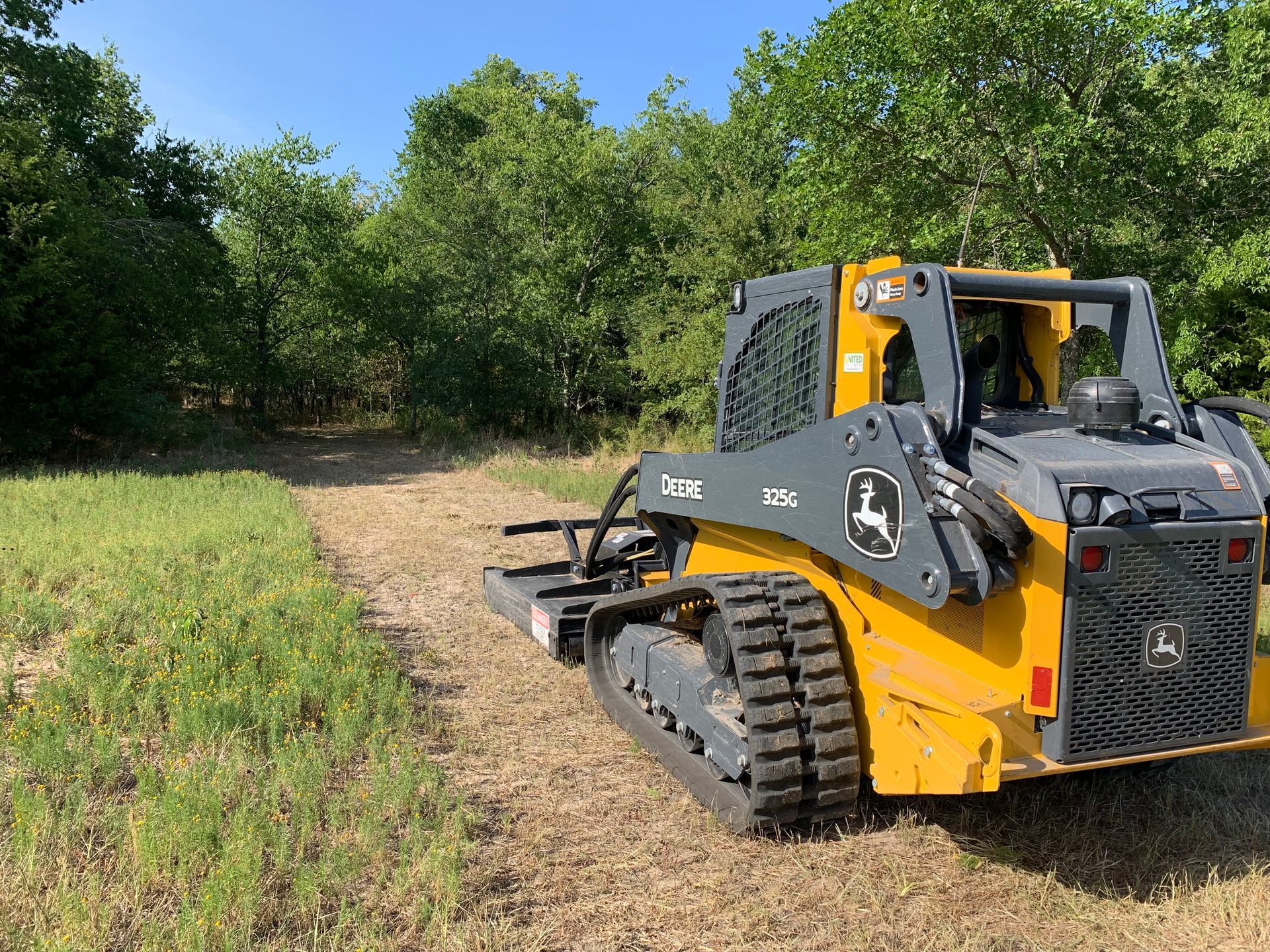 Skid steer road work, land clearing.