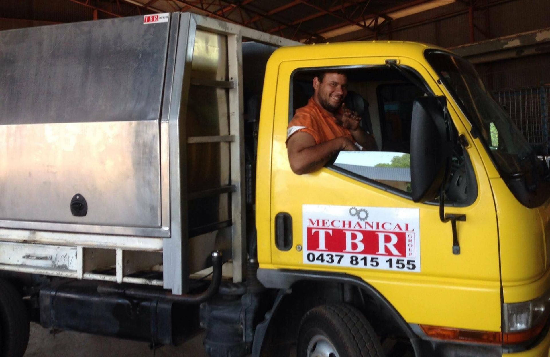 A Man Is Driving A Yellow Truck That Says Mechanical TBR — TBR Mechanical in East Arm, NT