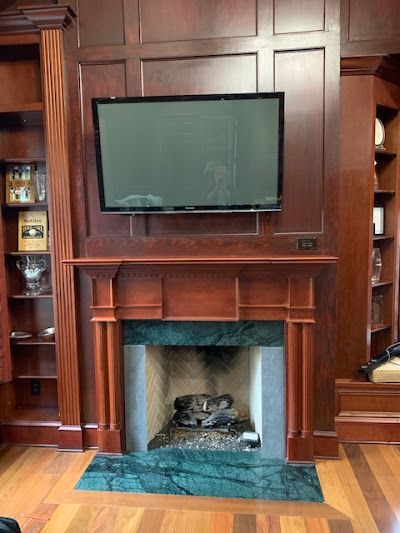 A fireplace with a flat screen tv above it