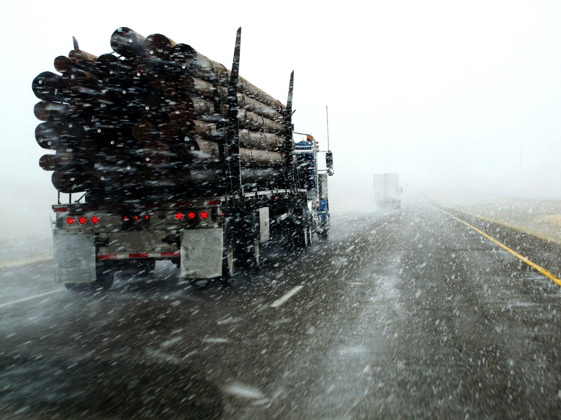 Heavy Truck Carrying Steel Pipes in Rain