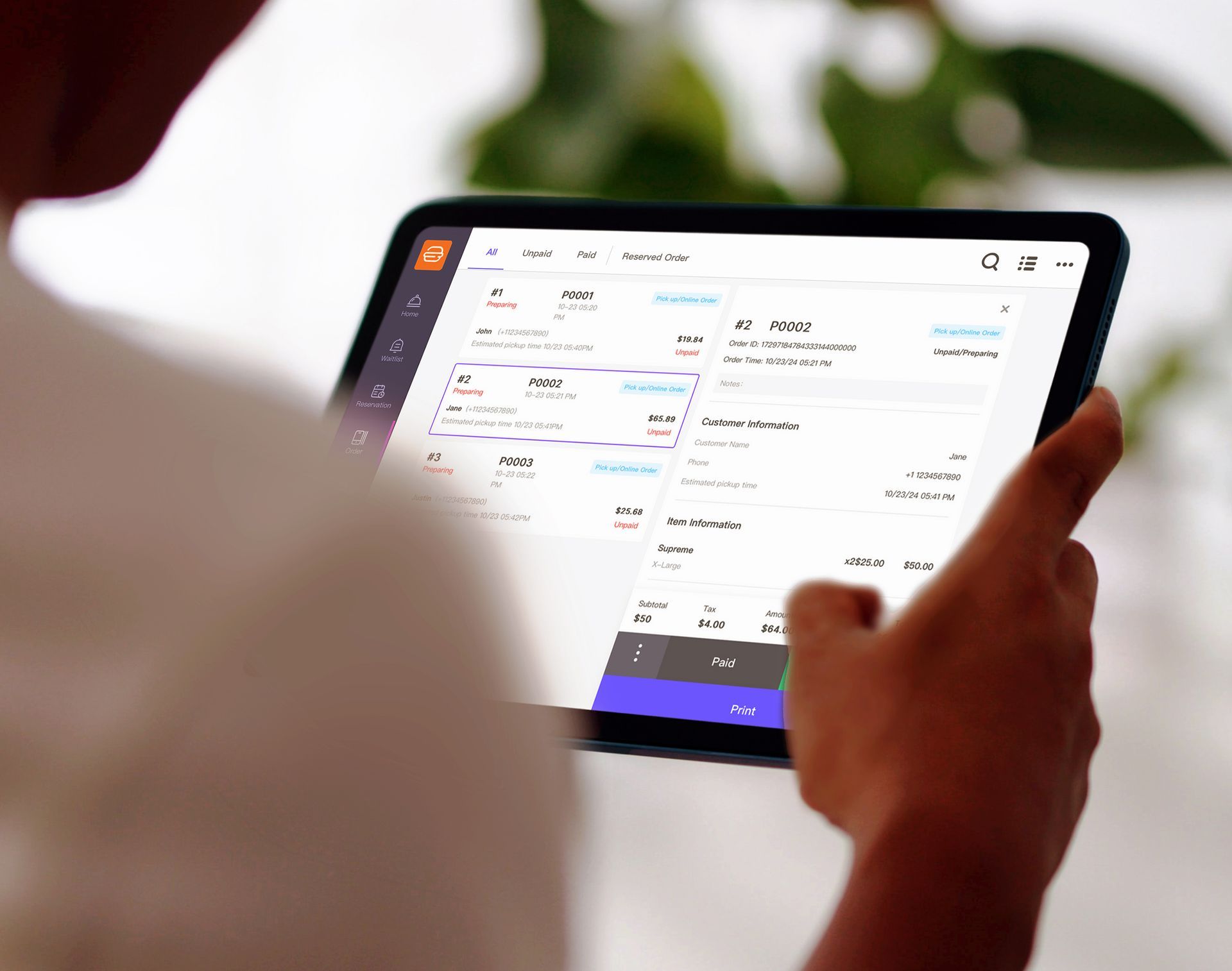 Closeup of restaurant staff marking online order as ready via Front Eats back office tablet interface.