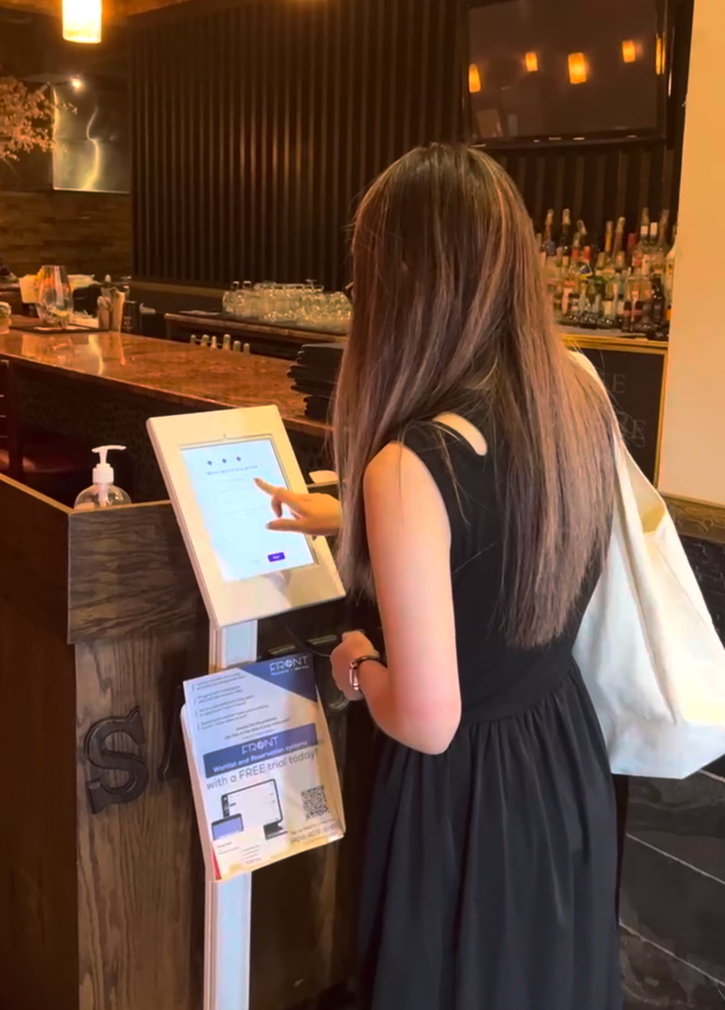 Front Waitlist restaurant waitlist software customer in store photo customer joining waitlist at the front of house