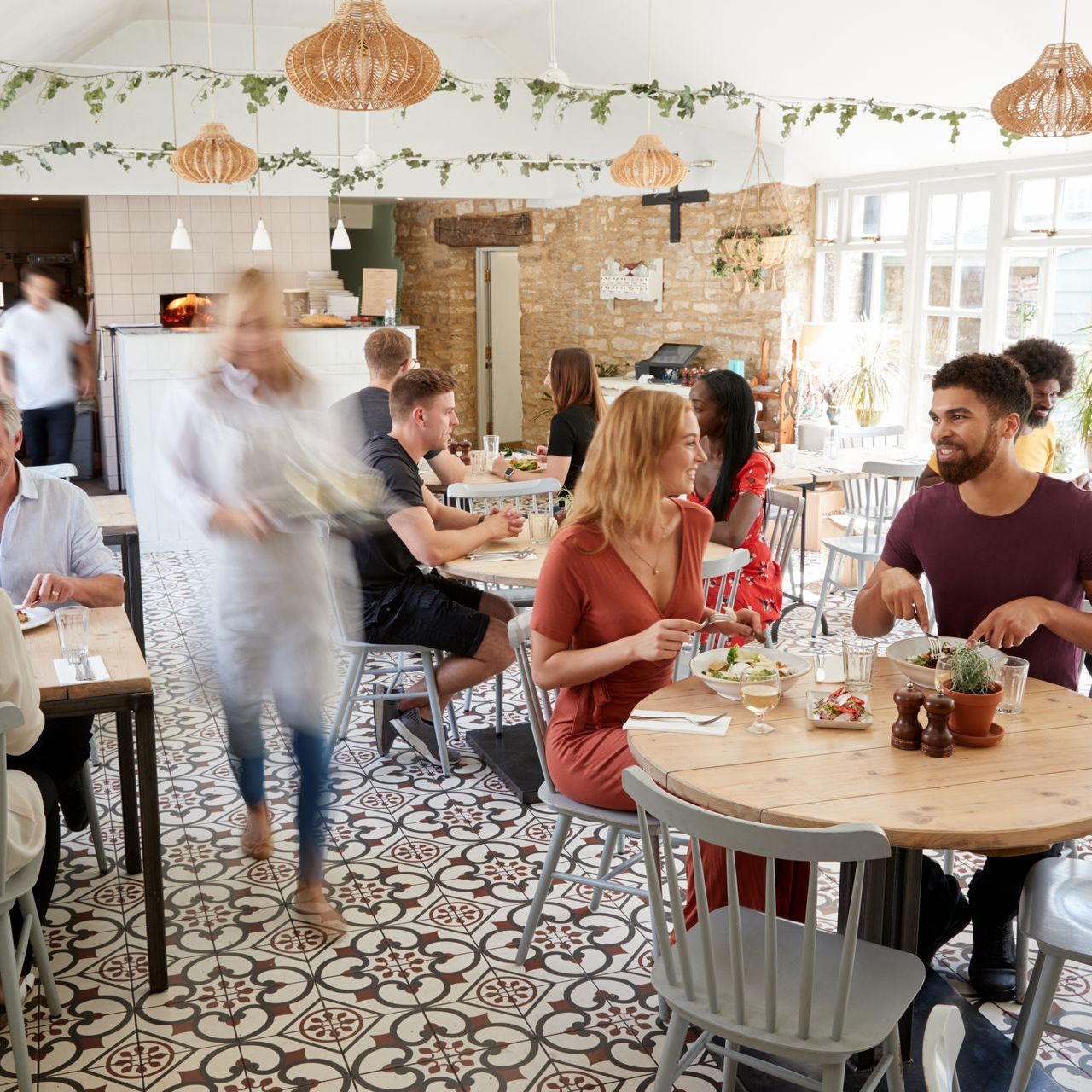 front restaurant waitlist in a busy full service restaurant with waiting customers