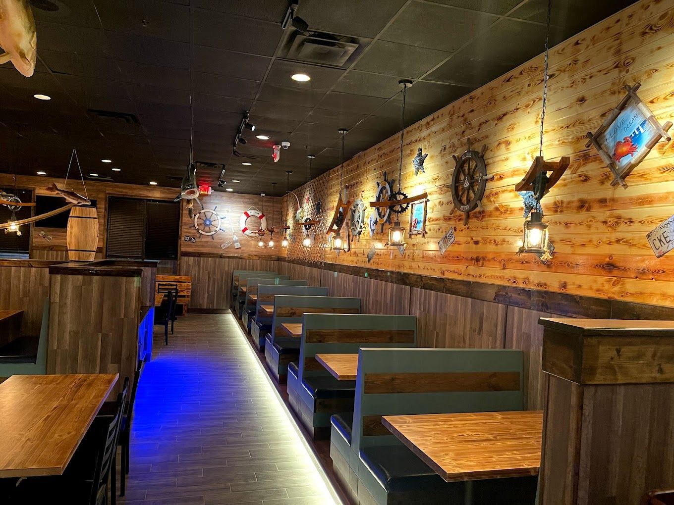 Front restaurant technology customer success Juicy Seafood restaurant interior with multiple booth seating along a wall